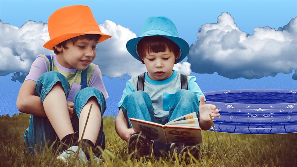 Two children reading a book